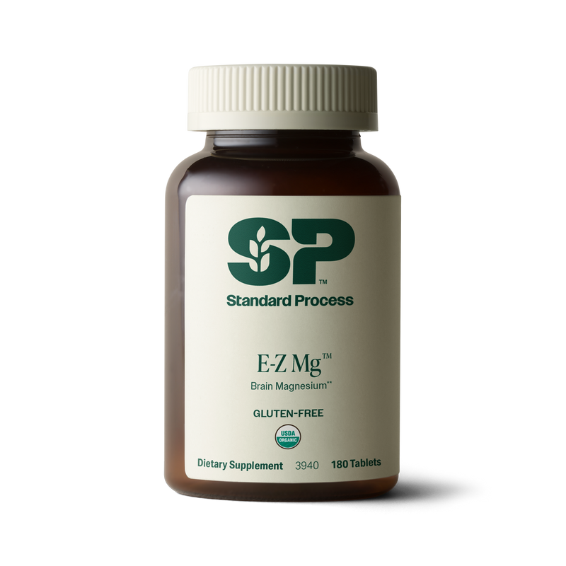 Image of E-Z Mg bottle next to tablets of magnesium supplements.